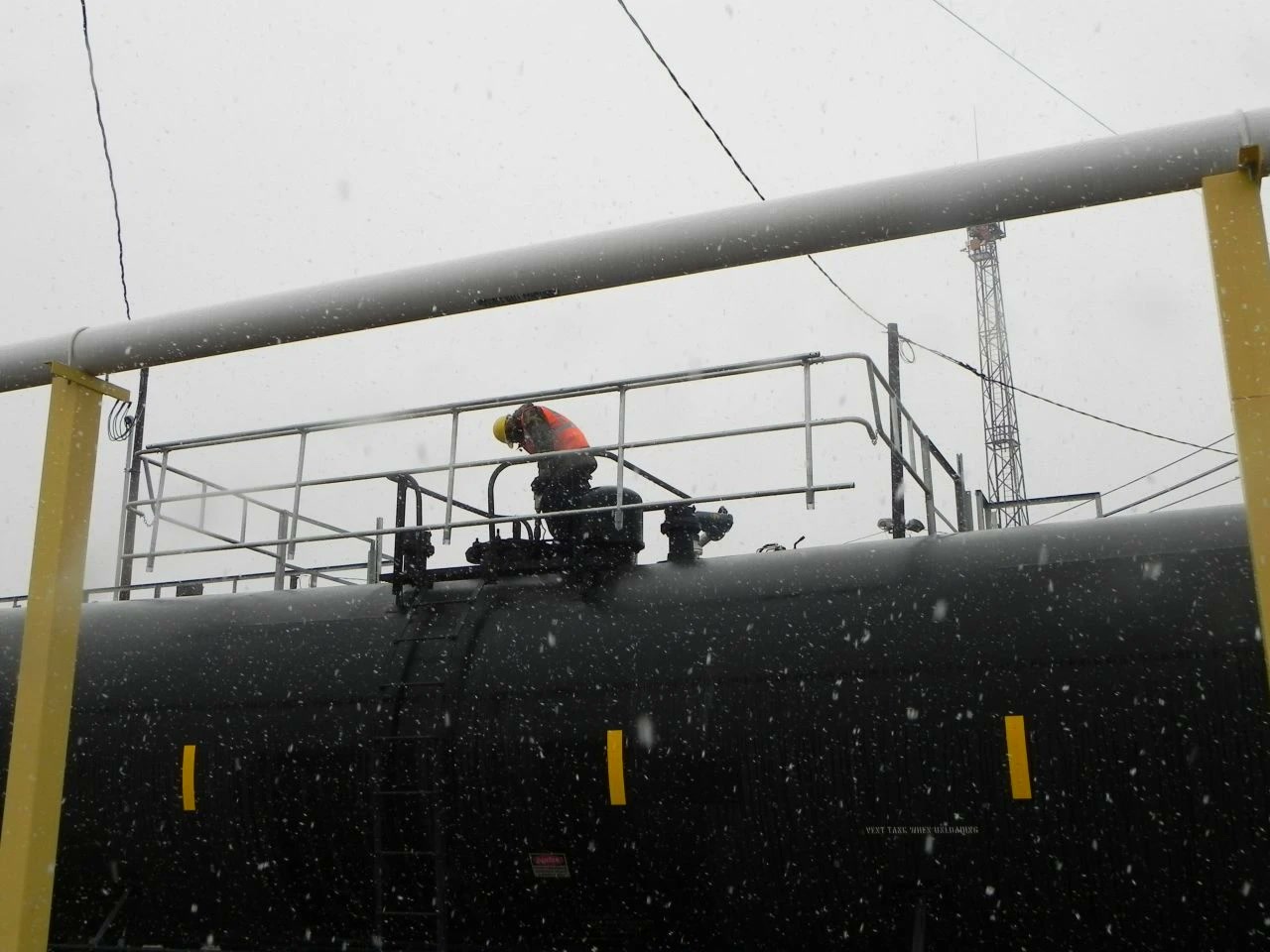 A railcar top in weather. The exposure that defines energy-country loading, and the reason winterized judgment matters.