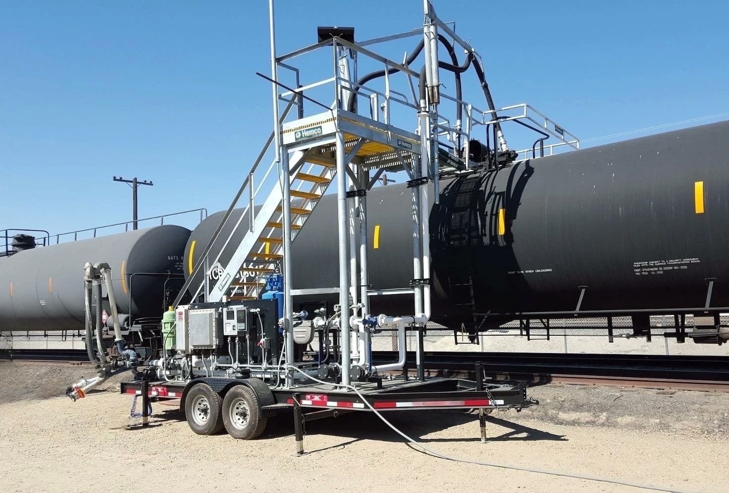 Mobile transload skid with gangway access and transfer system at a chemical site